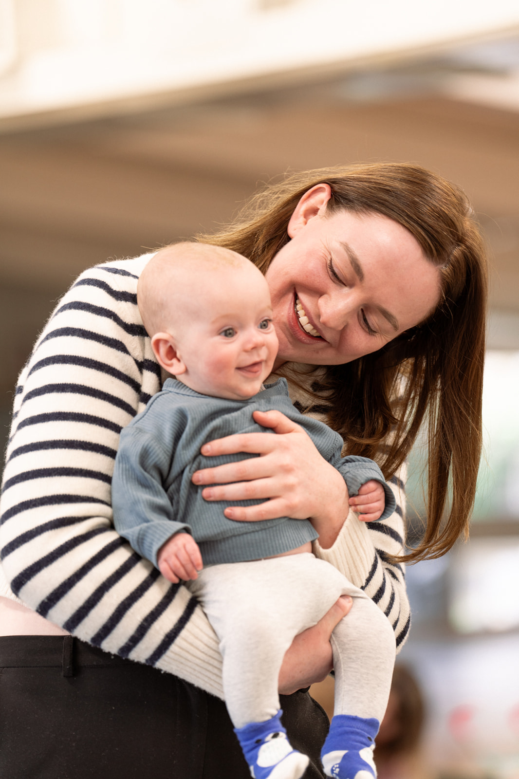 Woman in striped top holding a baby